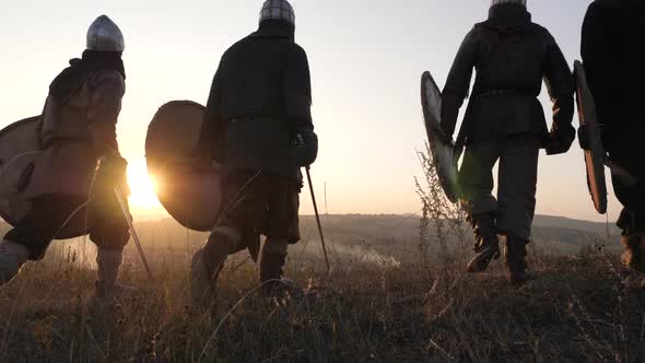 Medieval warriors walking at sunset