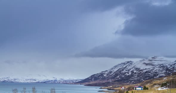 Cloud rolling time lapse over snow mountain fjords in Akureyri, Iceland.