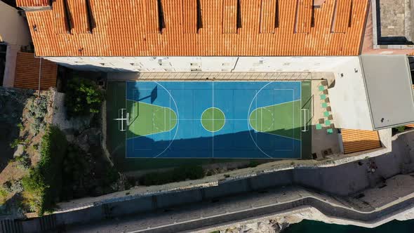 Healthy lifestyle. A team plays basketball on the court. The view from the air on the basketball