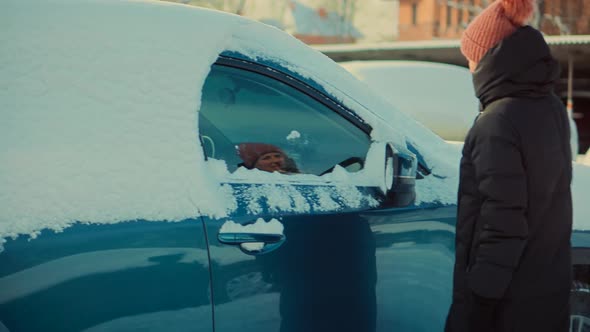 Washing Snow From Car.Sweep Snow From Automobile With Brushes In Winter.Scraping Ice From Glass.