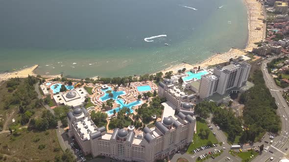 Aerial view of Sunny Beach city that is located on Black Sea shore. Top view of sand beaches with