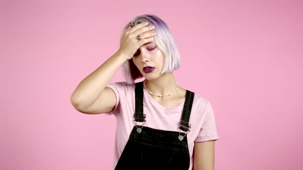 Portrait of Young Woman Doing Facepalm Gesture, Like No, I Forgot. Unhappy Woman with Violet Hair