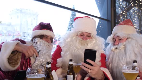 Santa Claus Holding a Smart Phone with a Christmas Massage Using a Mobile Application