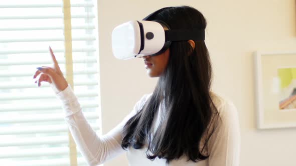 Woman using virtual reality headset in living room