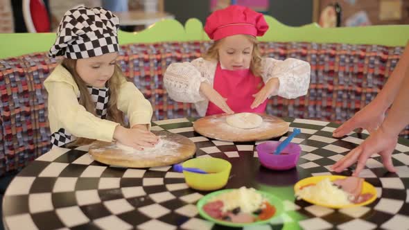 Children make pizza. Master class for children on cooking Italian pizza.