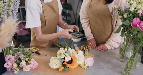 Two Young Woman Florist Working in a Flower Shop.