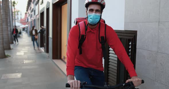 Man rider delivering meal with electric bicycle and thermal backpack