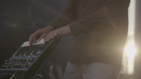 Musician playing electronic piano on a festival stage