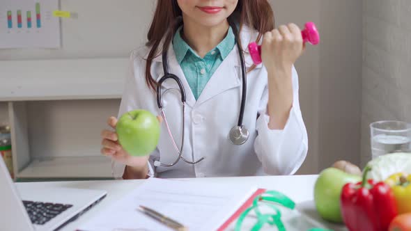 Nutritionist giving consultation to patient with healthy fruit and vegetable