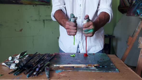 Artist Getting Ready To Paint By Mixing and Blending Paint