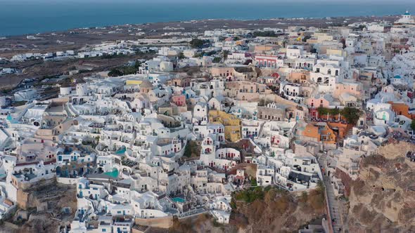 Aerial shot of famous Oia village in Santorini at sunrise in Greece