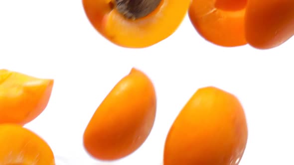 Halves Ripe Apricots Fly on White Background