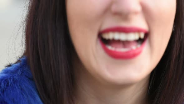 slow motion extreme close up woman mouth with piercing smiling