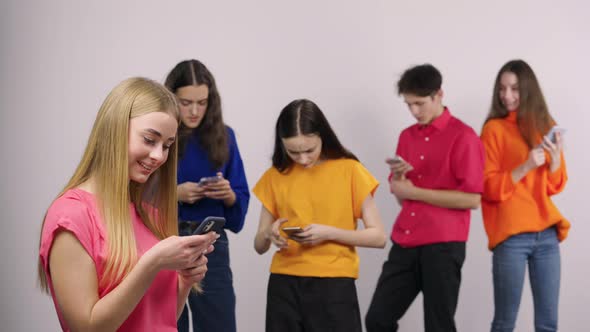 Group of Handsome Young People are Chatting Using a Mobile Phone or Browsing Information on Social