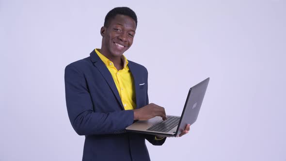 Young Happy African Businessman Using Laptop