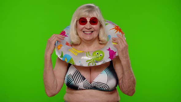 Elderly Woman Tourist in Swimsuit Dancing Celebrating Smiling with Rubber Ring on Chroma Key