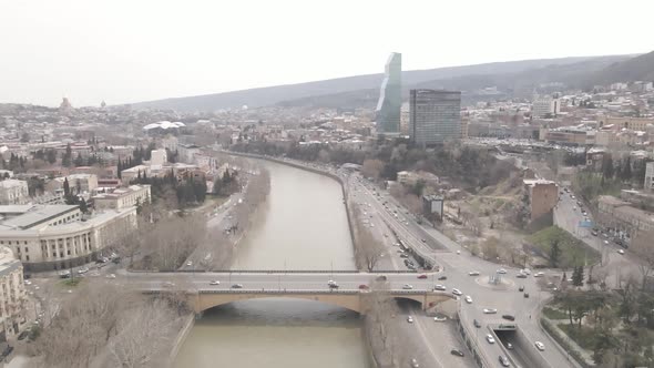 Aerial View of Galaktion Tabidze Bridge over Kura river in the centre of Tbilisi. Georgia 2021 April