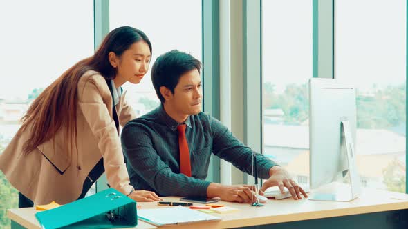 Two Business People Talk Project Strategy at Office