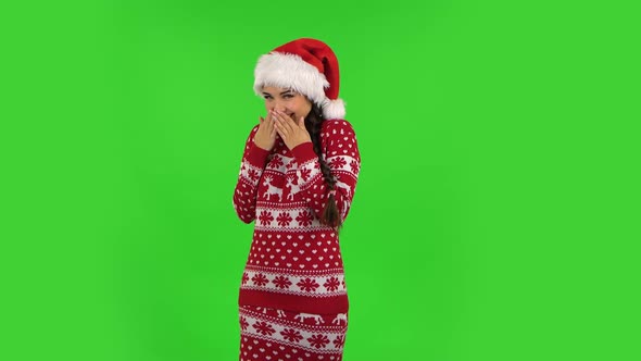 Sweety Girl in Santa Claus Hat Is Laughing and Having Fun. Green Screen