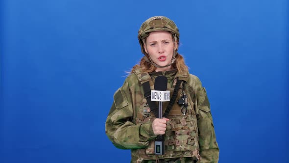 Female Reporter in Camouflage and Military Equipment Works in Extreme Conditions During a Military