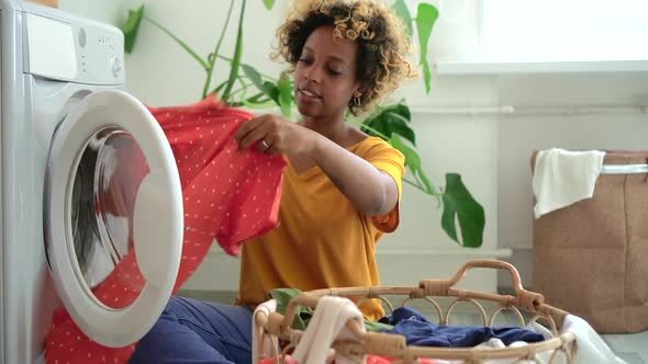 African American Woman Put Dirty Laundry in Washing Machine at Home Spbd. Female Do Housework