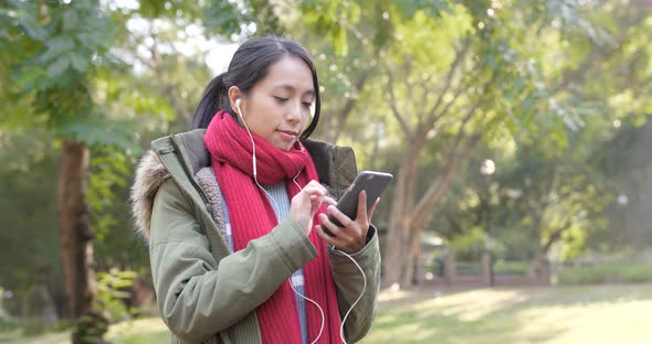 Woman use of mobile phone in citypark