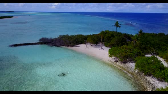 Aerial drone tourism of beautiful resort beach vacation by aqua blue water and white sandy backgroun