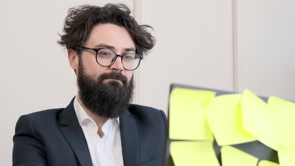 Bearded Man in Underwear and Jacket Working Remote Typing at Computer