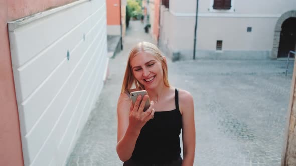 Pretty Blonde Woman Sharing Her Impressions From Summer Trip on Video Call on Smartphone