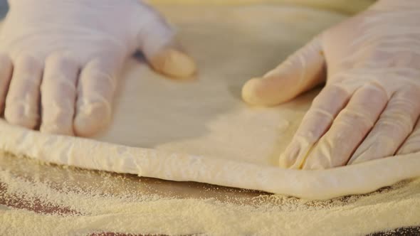 Chef Forming Dough for Pizza and Kneading It with Hands