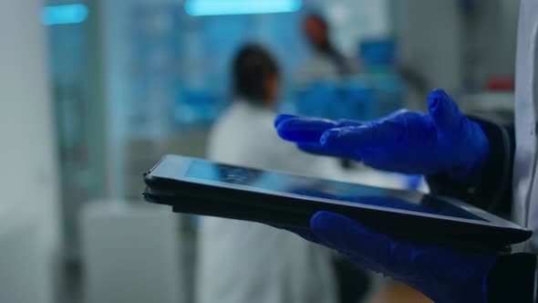 Close Up of Scientist Examining Datas From Tablet