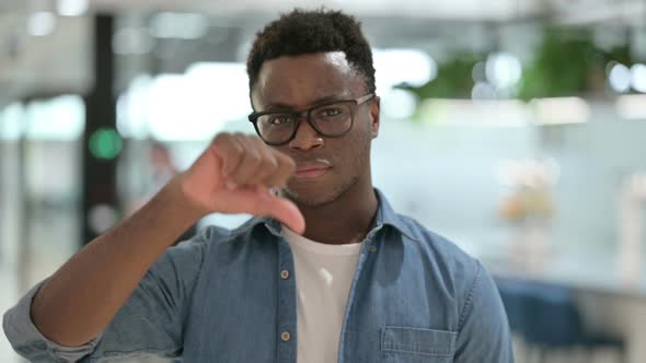 Portrait of Thumbs Down Gesture By Young African Man