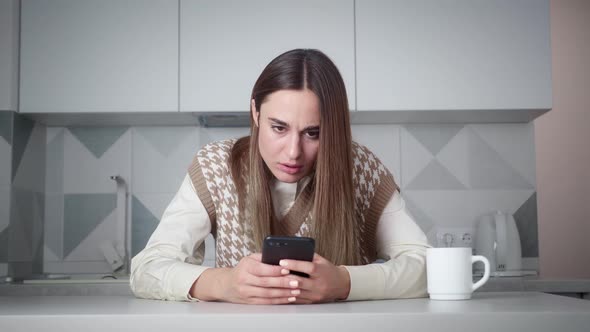 Young Woman Receives Bad News on Her Phone