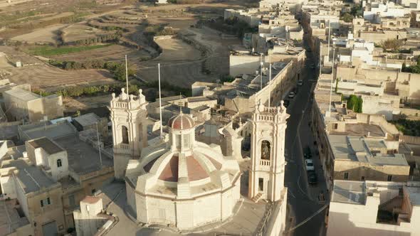 Brown Beige Church on Small Mediterranean Town Village Interchange Road Through City on Malta, Gozo