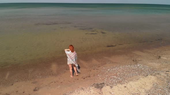 Epic Orbit Young Woman Standing Looking at Sea with Tent in Background During Traveling