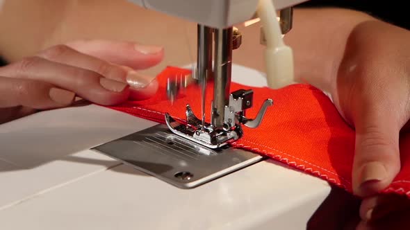 White Stitch on a Red Fabric. Slow Motion