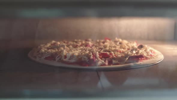 Putting pizza into oven. Italian Pizza in oven