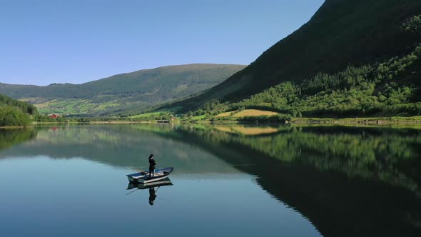 Woman on the Boat Catches a Fish on Spinning in Norway