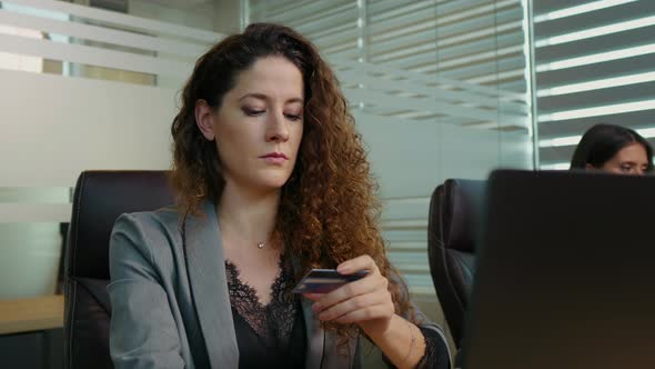 Woman with laptop and credit card buying online.