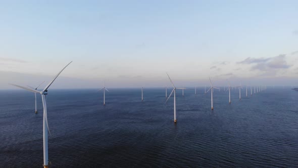 Offshore Windmill Park with Clouds and a Blue Sky Windmill Park in the Ocean Drone Aerial View with