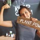 Vegan Girl Holding Wooden Sign Plant Power and Showing Strong Biceps. Healthy Lifestyle Propaganda - VideoHive Item for Sale