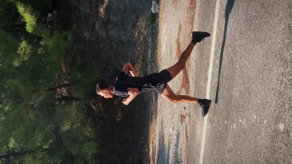 Triathlete running outdoors. Vertical video