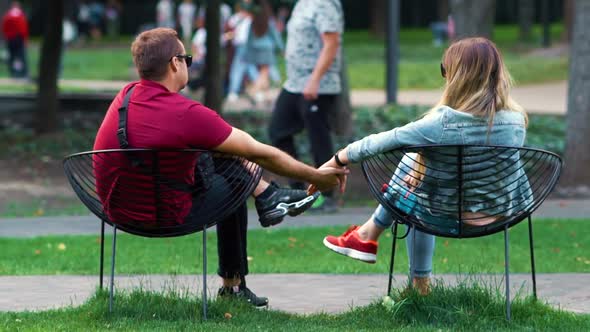 Romantic Couple Holding Hands in Public Park