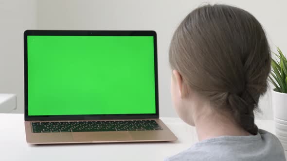 School Girl Studying During Online Lessons in Front of Green Screen Laptop Back View