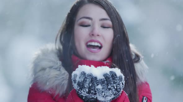 Woman blowing snow