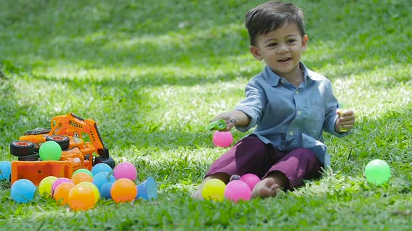 Little Boy Happy On The Grass In The Park