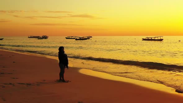 Girl sunbathes on exotic seashore beach voyage by shallow lagoon and bright sandy background of the 