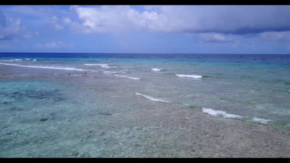 Aerial drone shot panorama of relaxing bay beach lifestyle by shallow water and bright sand backgrou