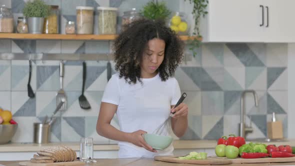 Healthy Young African Woman Cooking in Kitchen