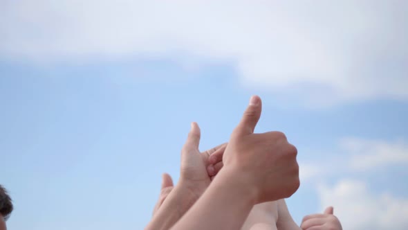 A Group of Friends Raise Their Hands with Their Fingers Up.